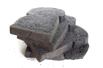Black charcoal bread on white background.