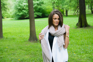 beautiful girl with a scarf on a walk in the park