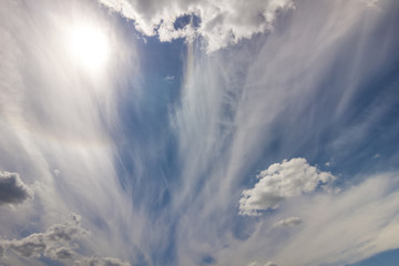 Dramatic blue sky with puffy white clouds in bright clear sunny