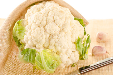 Cauliflower with burlap sack on white