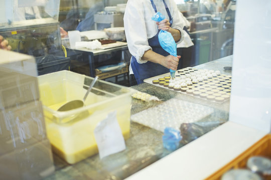 Confectioner decorating pralines