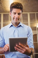 Business man posing with his tablet