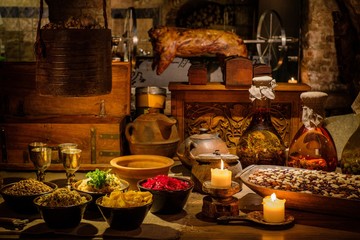 Medieval ancient kitchen table with typical food in royal castle.