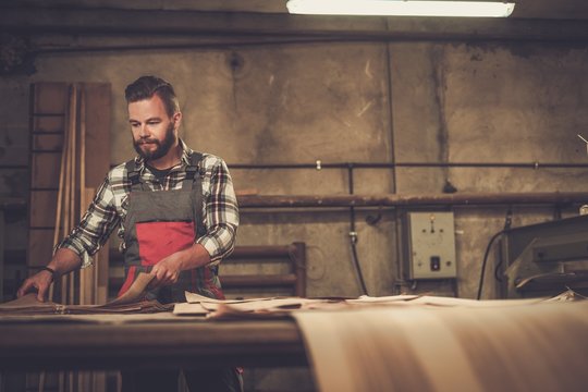 Carpenter doing his job in carpentry workshop.