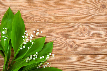 Lily of the valley on a wooden background 