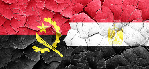 Angola flag with egypt flag on a grunge cracked wall
