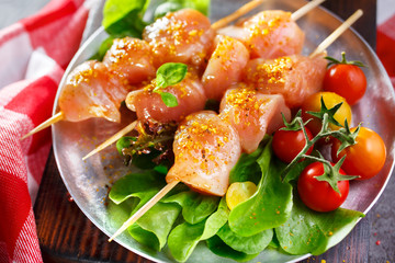 Raw chicken on wood skewers
