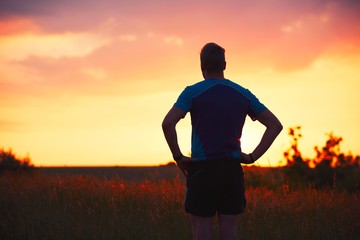 Pensive runner at the sunset