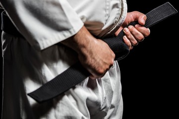 Fighter tightening karate belt © WavebreakMediaMicro
