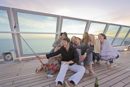 Group of friends taking selfies on a cruise