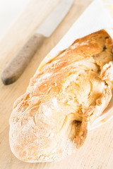 Selbst gebackenes Baguette liegt auf einem Holzbrett