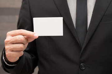 Hand of businessman showing white paper
