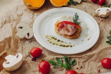 Rosti potato with bacon and poached egg on parchment background