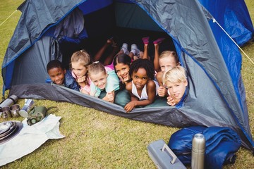  Smiling kids lying in the tent together
