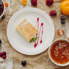 Casserole on parchment background, square crop, flat lay, top view