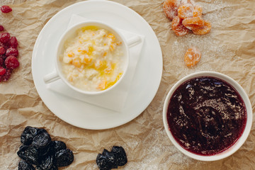 Millet porridge with pumpkin. Parchment background. Flat Lay.