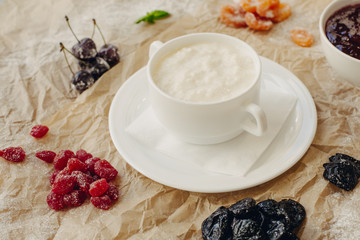 Rice porrige with berries on parchment background