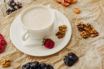 Oat meal with walnuts and berries. Parchment background.