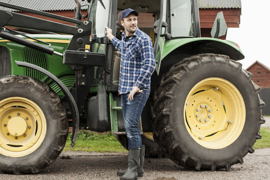 Man standing next to tractor