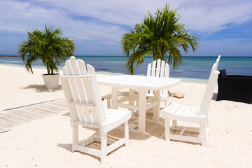 restaurant table and chairs on the beach