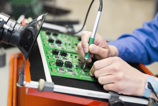 Close up of man working with integrated circuit