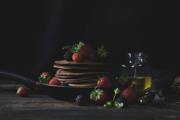 Rustic breakfast in the country side with pancakes and strawberr