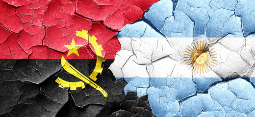 Angola flag with Argentine flag on a grunge cracked wall