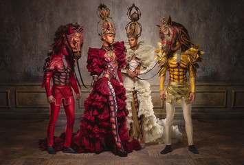 Chess queens with men in horse masks