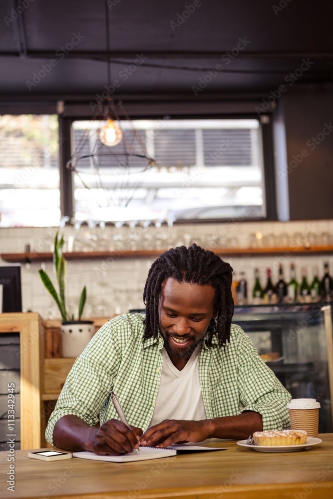 Poster Man writing in a notebook