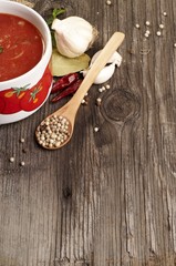 Domestic tomato soup in bowl with paper for recipe