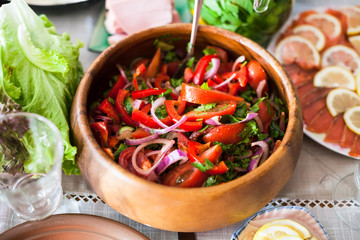salad from tomatoes, cucumbers on served table