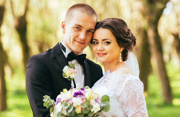 close up portrait of beautiful bride and groom touching forehead