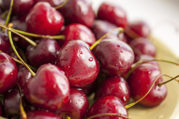 Cherries on the plate with water drops - macro background