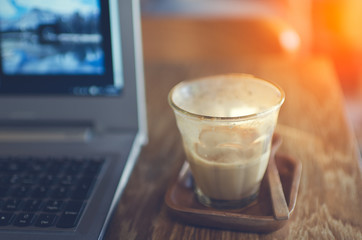 Coffee cup and laptop for business, Selective focus on coffee an