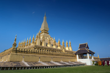 Group of Buddhist monks walking around That Luang Stupa, landmark of Vientiane, Lao PDR