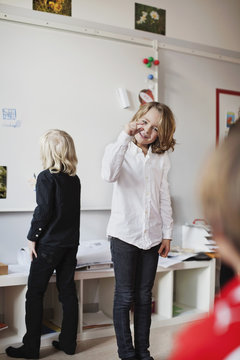 Students playing guess game in classroom