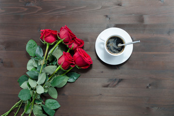 cup of coffee and red roses