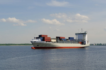 Cargo ship sailing in still water