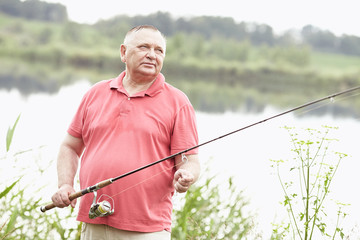 Mature angler on lake