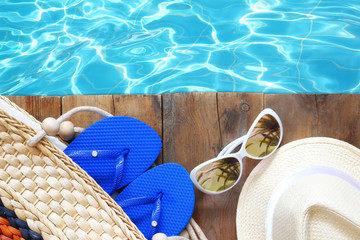 swimming pool and wooden deck with beach accessories