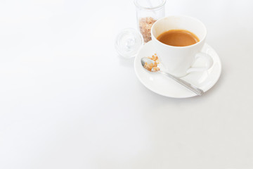 White cup of coffee on white wood table