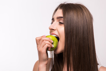 Young girl  eat apple. Female teeth  and apple. Healthy eating on white background