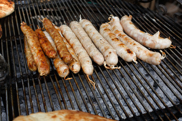 Street fast food, grilled sausages at bbq