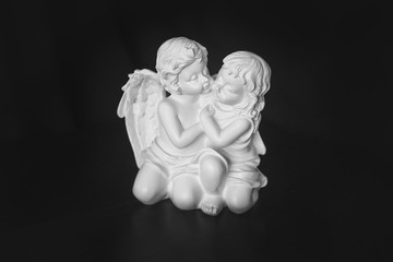 figurine of angels on a black background with backlight