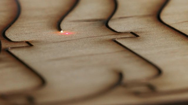 Laser cutting on wood. Slow motion.