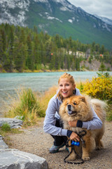 Portrait of the beautiful girl with chow-chow dog