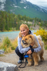 Portrait of the beautiful girl with chow-chow dog