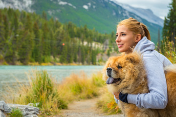 Portrait of the beautiful girl with chow-chow dog
