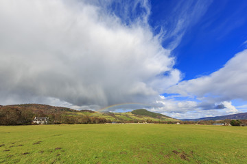 Beautiful rainbow with fields, houses