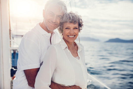 Loving mature couple standing on boat